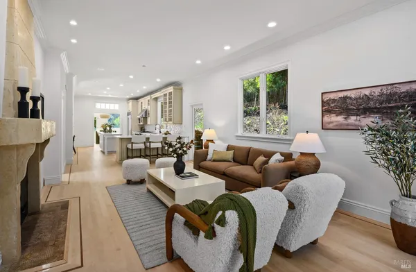 a living room with fireplace furniture and a large window