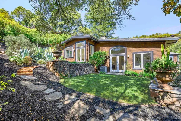 a front view of a house with a garden