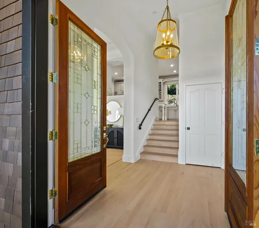 a view of entryway and hall with wooden floor