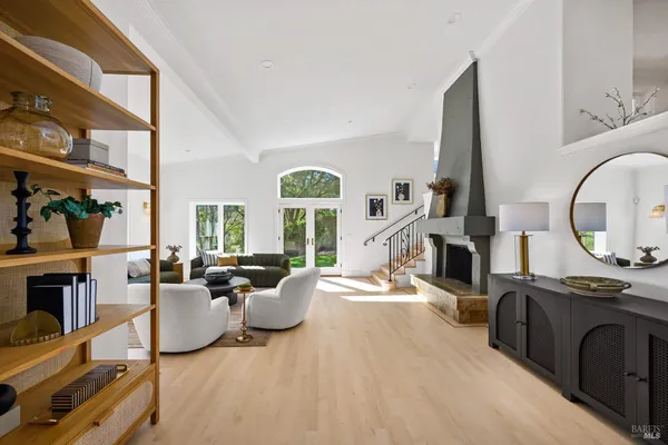 a living room with fireplace furniture and a large window