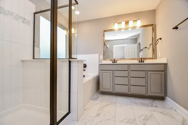 an empty room with windows and ceiling fan