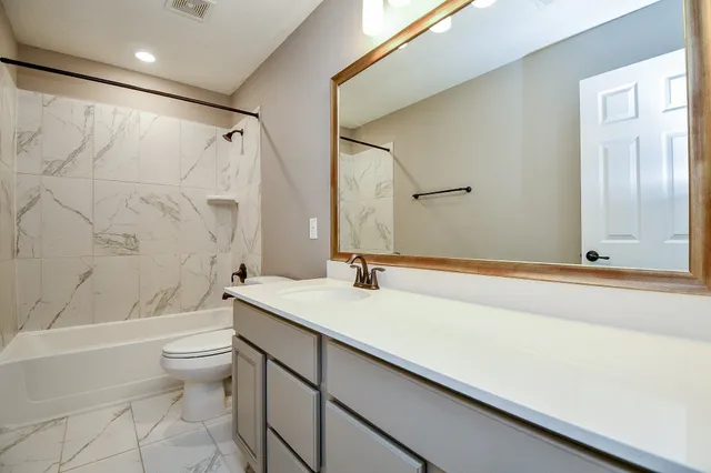 a bathroom with a sink a mirror and a toilet