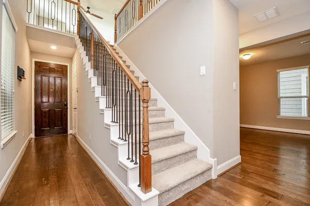 a view of entryway and hall with wooden floor