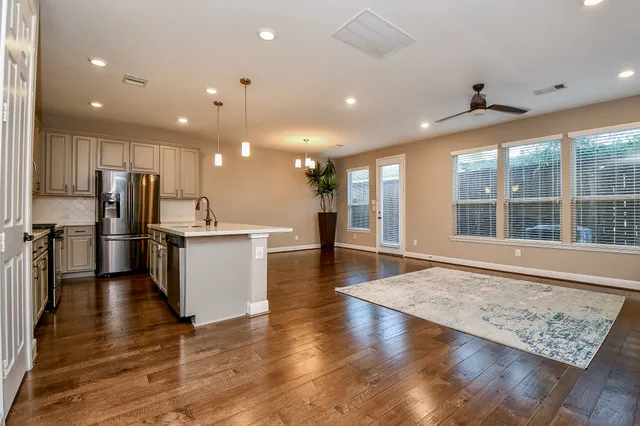 a view of kitchen with cabinets stainless steel appliances and a window
