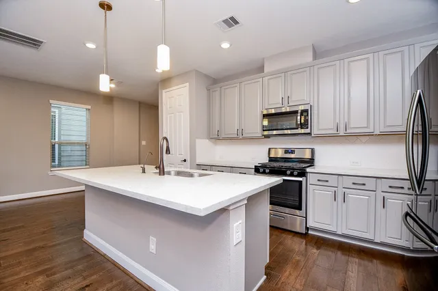 a view of kitchen with cabinets and wooden floor