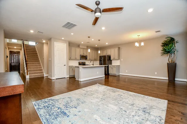 a living room with furniture kitchen view and a table