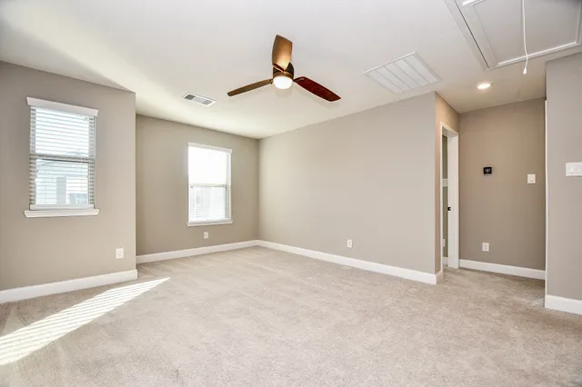 a view of empty room with ceiling fan