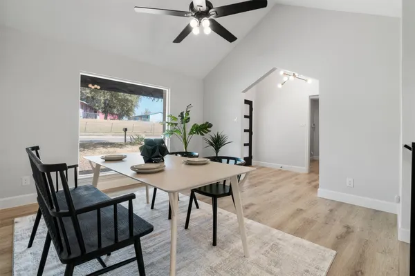 a living room with furniture a fireplace and a ceiling fan