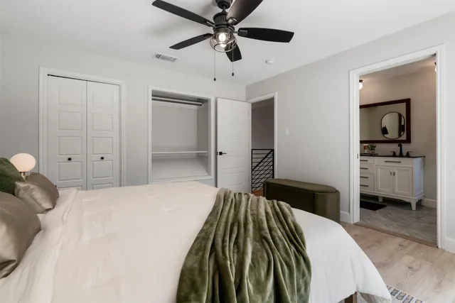 a bedroom with a bed and a walk in closet