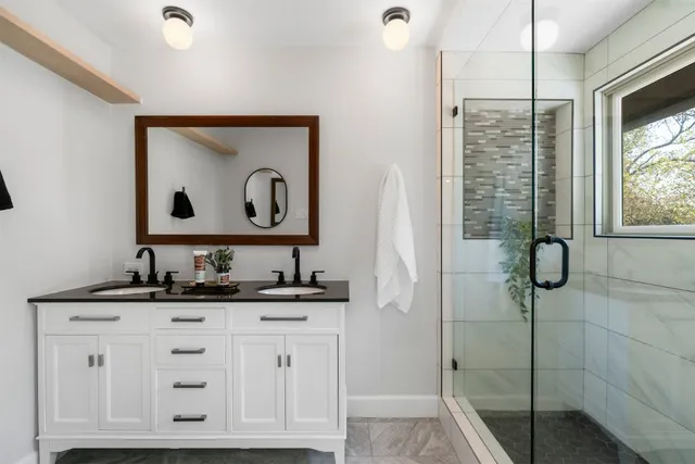 a bathroom with a sink vanity and a mirror