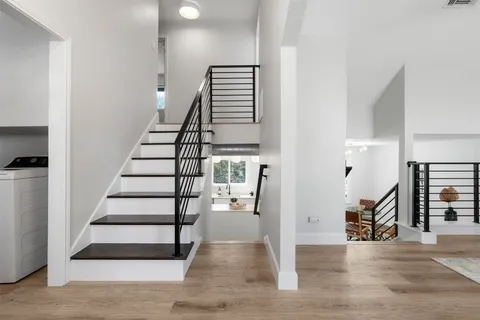 a view of entryway and hall with wooden floor