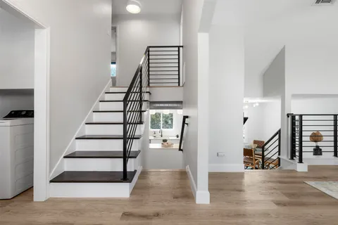 a view of entryway and hall with wooden floor