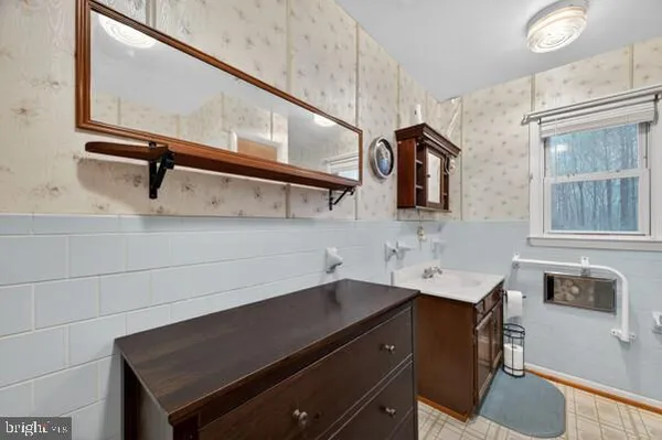 a bathroom with a tub a sink and mirrors