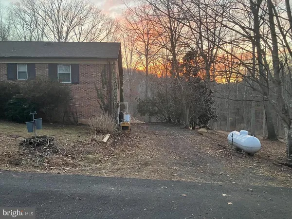 a backyard of a house with a tree