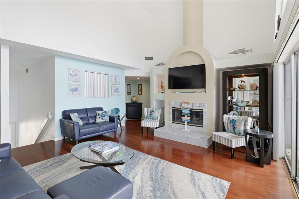 7324 Islander Lane Hudson, FL 34667 - Photo 12 of 35 a living room with furniture a fireplace and a flat screen tv