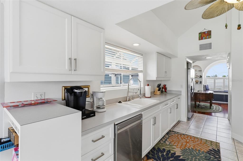 7324 Islander Lane Hudson, FL 34667 - Photo 14 of 35 a kitchen with a sink dishwasher stove and white cabinets