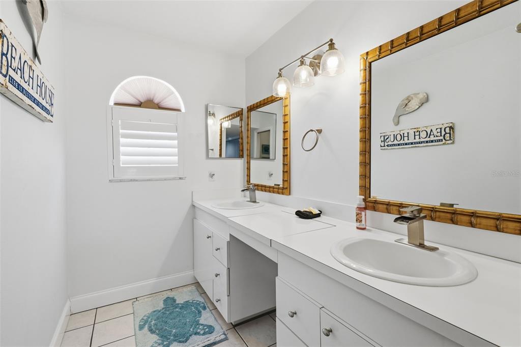 7324 Islander Lane Hudson, FL 34667 - Photo 21 of 35 a bathroom with a double vanity sink window and mirror
