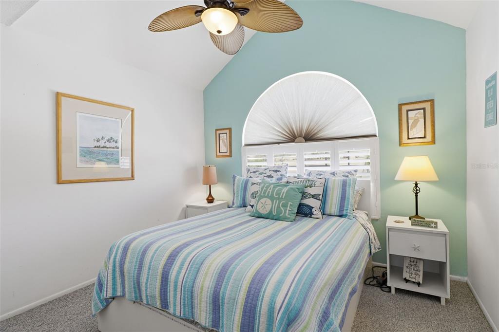 7324 Islander Lane Hudson, FL 34667 - Photo 22 of 35 a bedroom with a bed and a chandelier