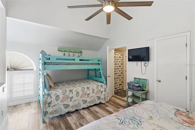 a bedroom with a bed and a tv