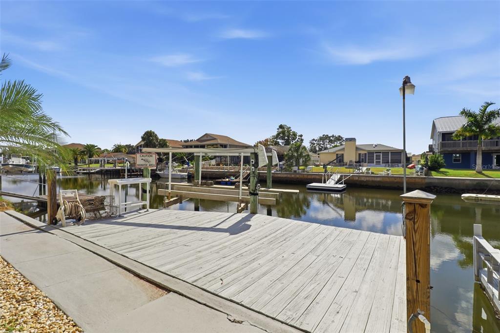 7324 Islander Lane Hudson, FL 34667 - Photo 35 of 35 a view of a lake with boats and palm trees