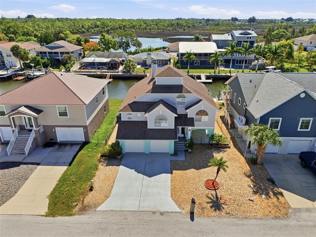 7324 Islander Lane Hudson, FL 34667 - Photo 5 of 35 a aerial view of a house with a garden and lawn chairs