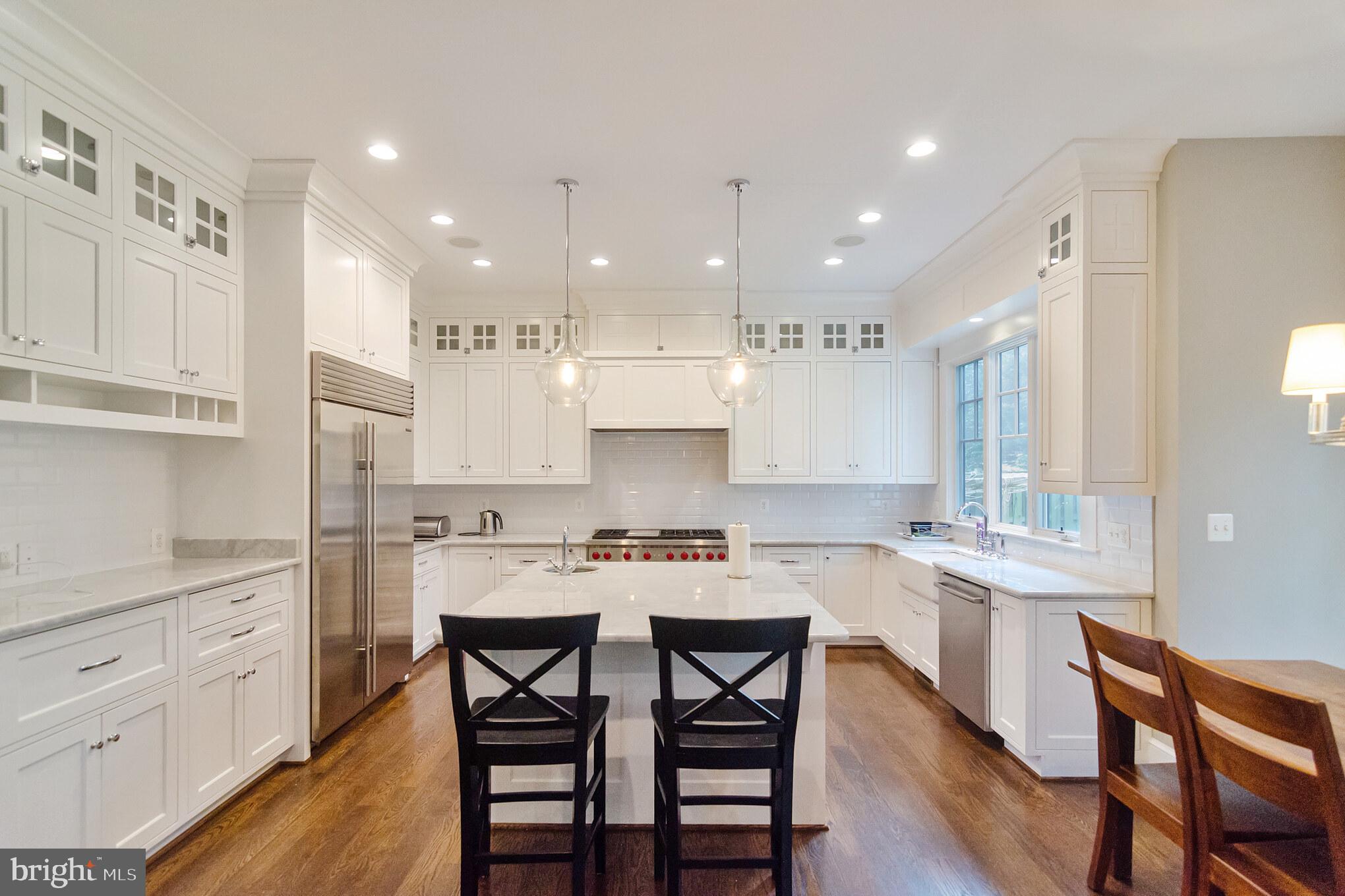 6801 Danforth Street McLean, VA 22101 - Photo 5 of 29 a kitchen with a dining table chairs sink and cabinets