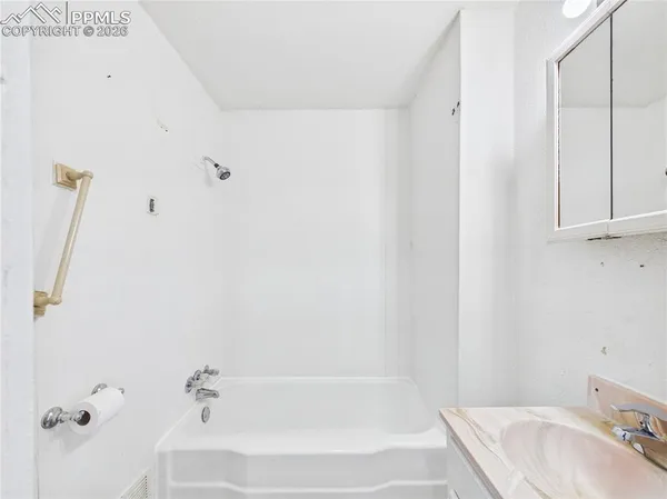 a bathroom with a tub and sink