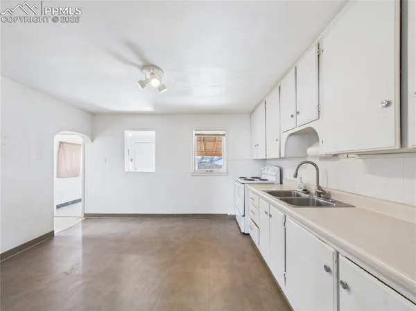 a kitchen with granite countertop a sink and cabinets