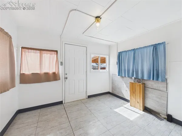 a view of an empty room and bathroom