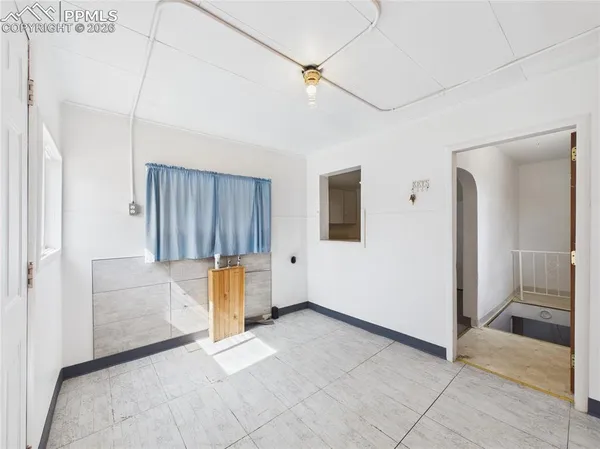 a view of a livingroom with furniture and cabinet door