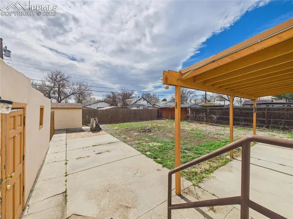 a view of a backyard with a small deck