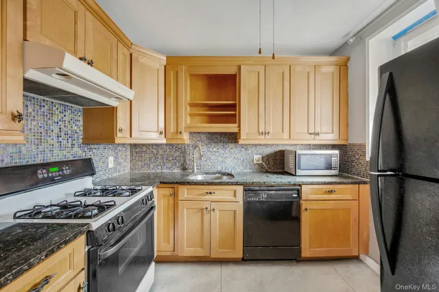 a kitchen with a stove top oven sink and refrigerator