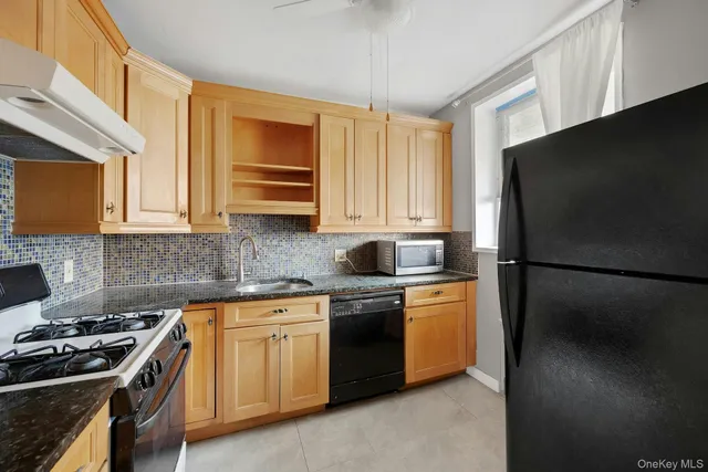 a kitchen with stainless steel appliances a stove a refrigerator a sink a cabinets and a counter top space