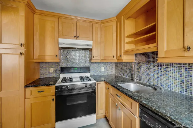 a kitchen with a sink stove and cabinets