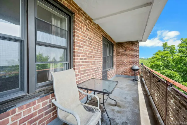 a view of a patio with table and chairs and wooden floor