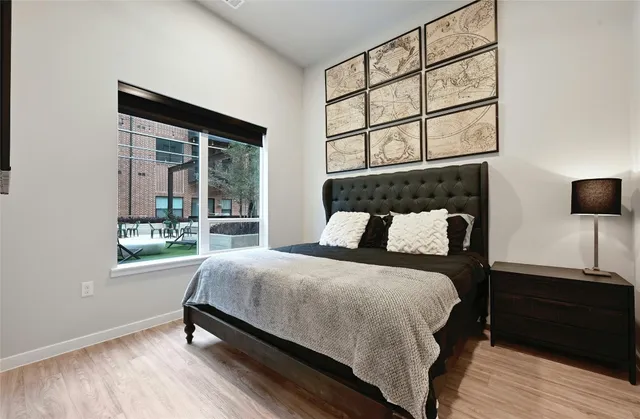 a bedroom with a bed and a window