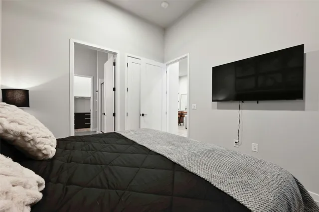 a bedroom with a bed and a flat screen television