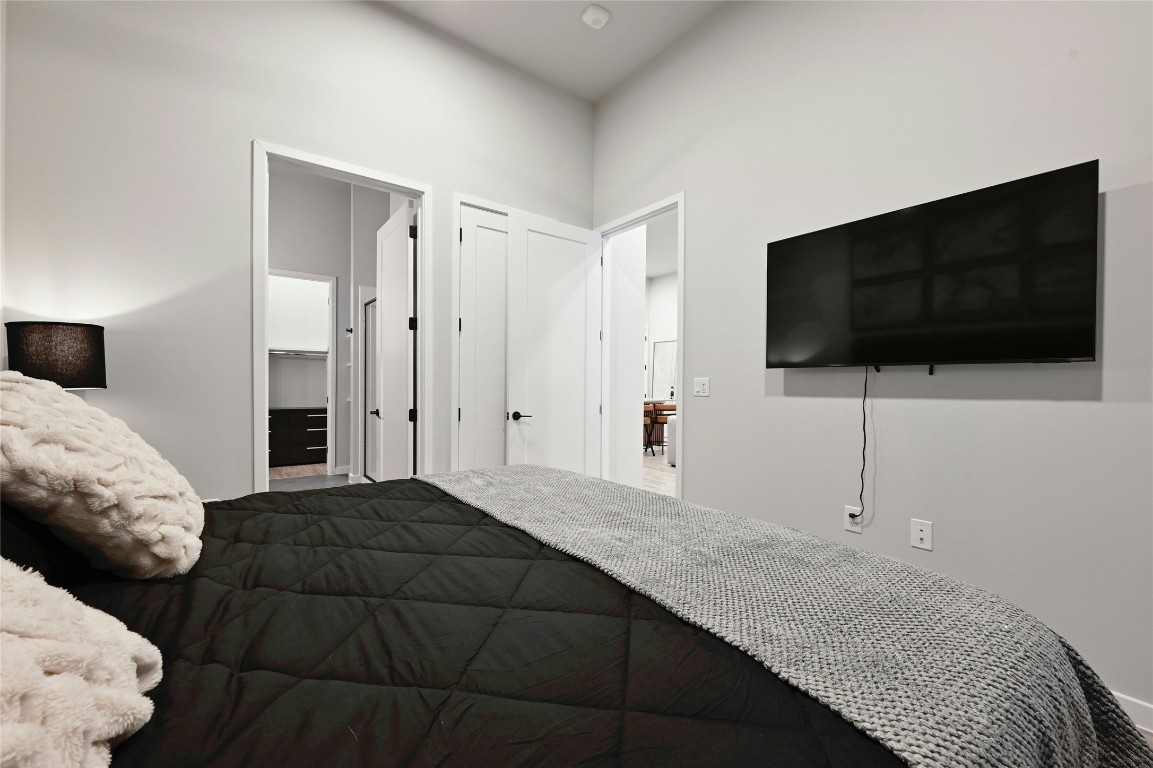 4510 Terry-O Lane, Unit 138 Austin, TX 78745 - Photo 13 of 40 a bedroom with a bed and a flat screen television