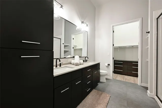 a bathroom with a double vanity sink and mirror