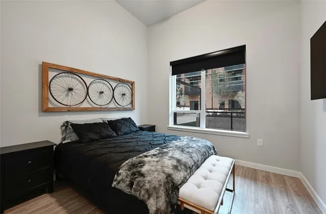 a bedroom with a bed and wooden floor