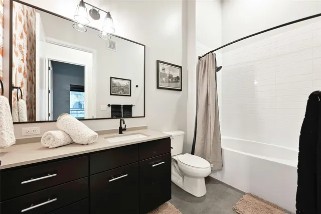 a bathroom with a toilet a sink and a mirror