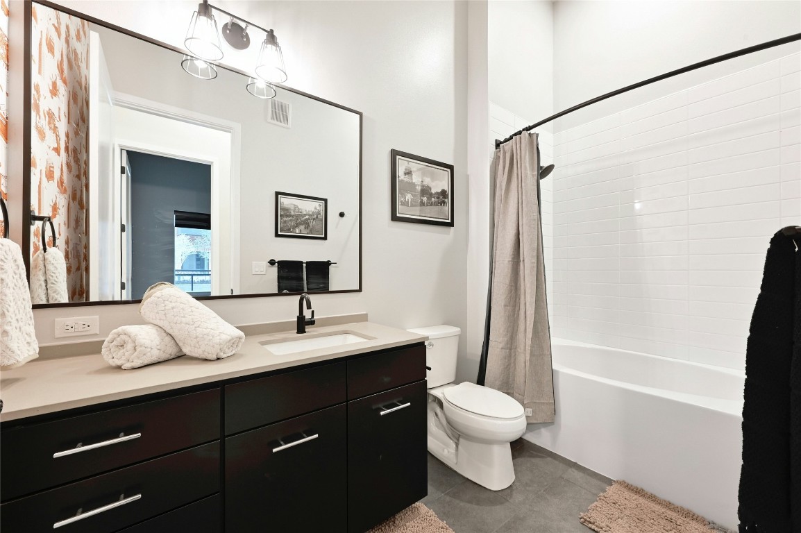 4510 Terry-O Lane, Unit 138 Austin, TX 78745 - Photo 18 of 40 a bathroom with a toilet a sink and a mirror