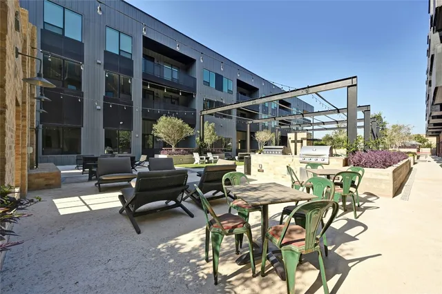 a view of a patio with dining table and chairs with wooden floor and fence