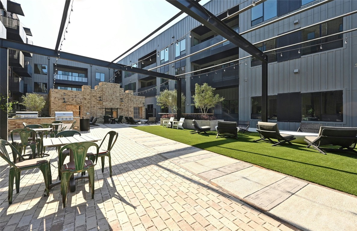4510 Terry-O Lane, Unit 138 Austin, TX 78745 - Photo 29 of 40 a view of a patio with table and chairs with wooden floor and fence