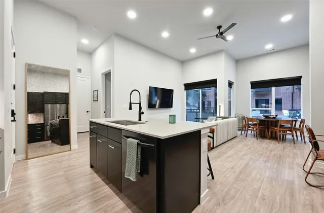 a kitchen with stainless steel appliances kitchen island granite countertop a sink and cabinets
