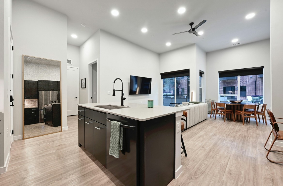 4510 Terry-O Lane, Unit 138 Austin, TX 78745 - Photo 5 of 40 a kitchen with stainless steel appliances kitchen island granite countertop a sink and cabinets