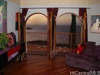 a bedroom with furniture and a wooden floor