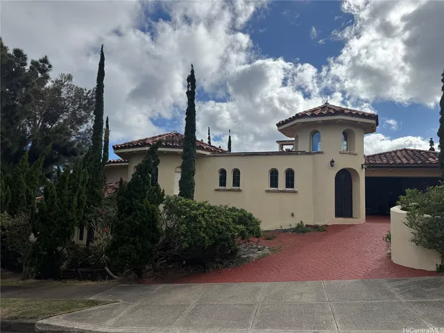 a white house with a yard and a garden