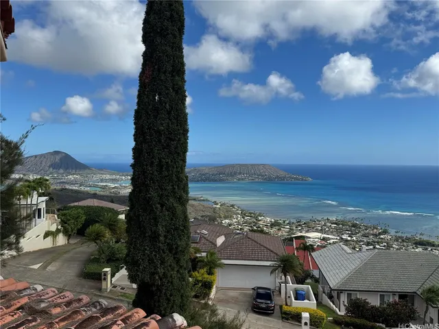 a living room with furniture and painting on the wall
