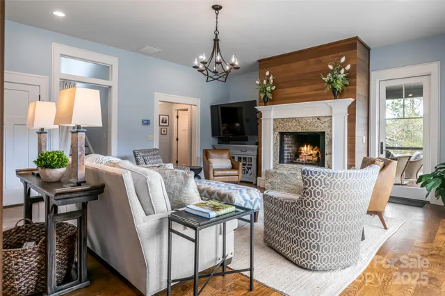 a living room with furniture fireplace and window